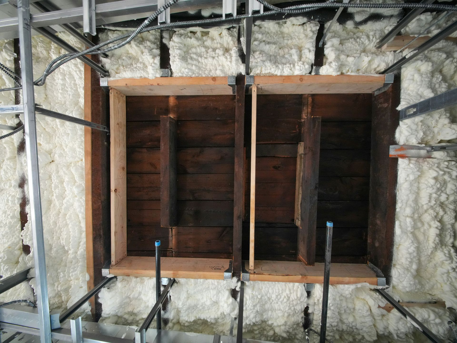 Wooden wall section with spray foam insulation