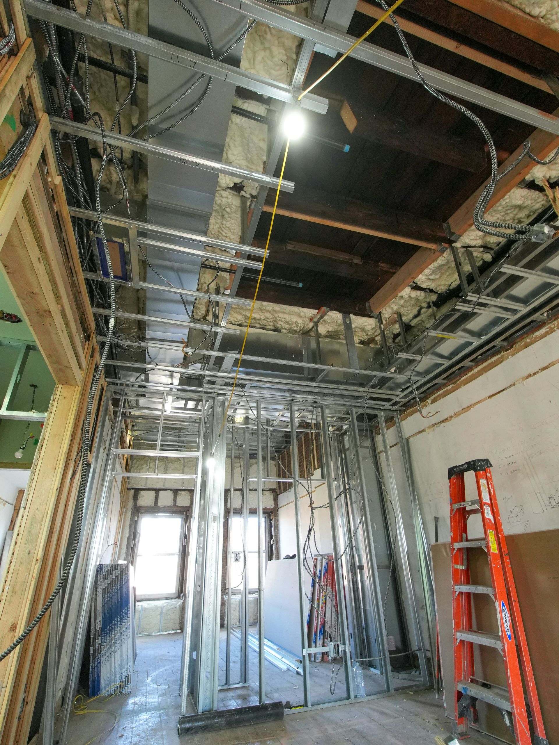 Interior construction with exposed framing and wiring